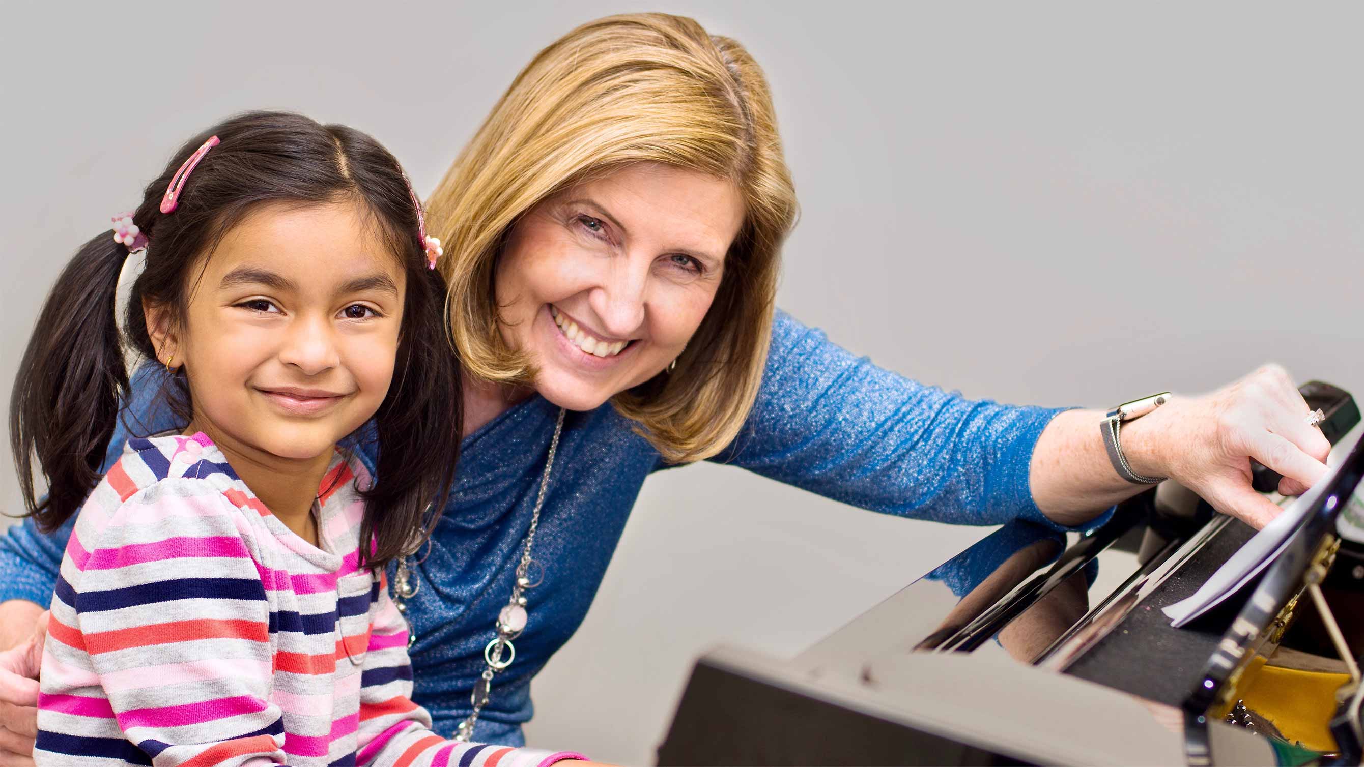 Photo of girl in piano lesson
